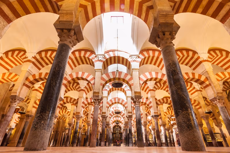 The iconic red and white striped arches inside the Mosque-Cathedral of Córdoba
